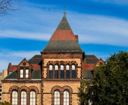 Free Classic brown university facade against a clear blue sky, capturing architectural elegance. Stock Photo
