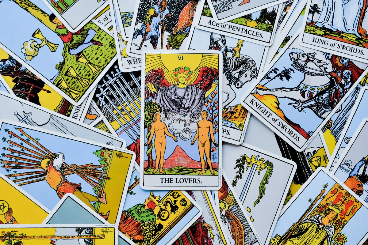 A spread of tarot cards including the Lovers, Knight of Swords and King of Swords