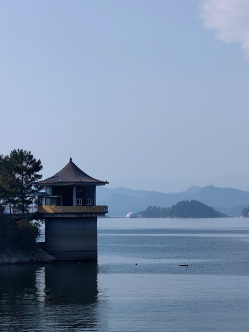 Photo of a Coast with a Lighthouse 