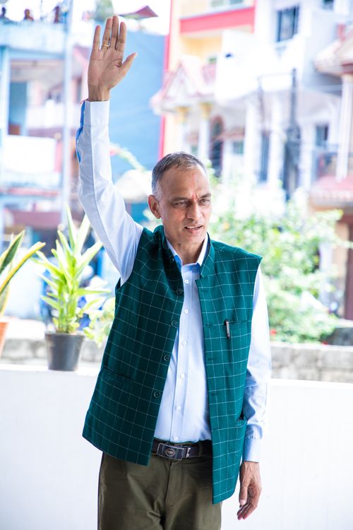 Free Adult man with raised arm in urban setting during daytime. Stock Photo