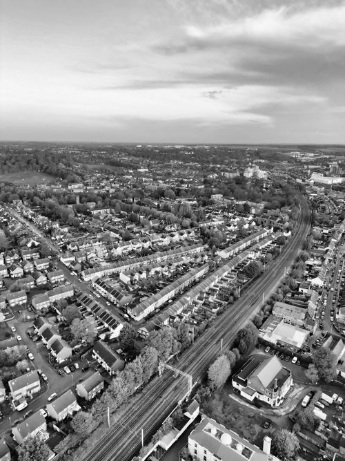 Free A stunning aerial black and white view of Luton's urban landscape, showcasing rows of houses and a railway line. Stock Photo