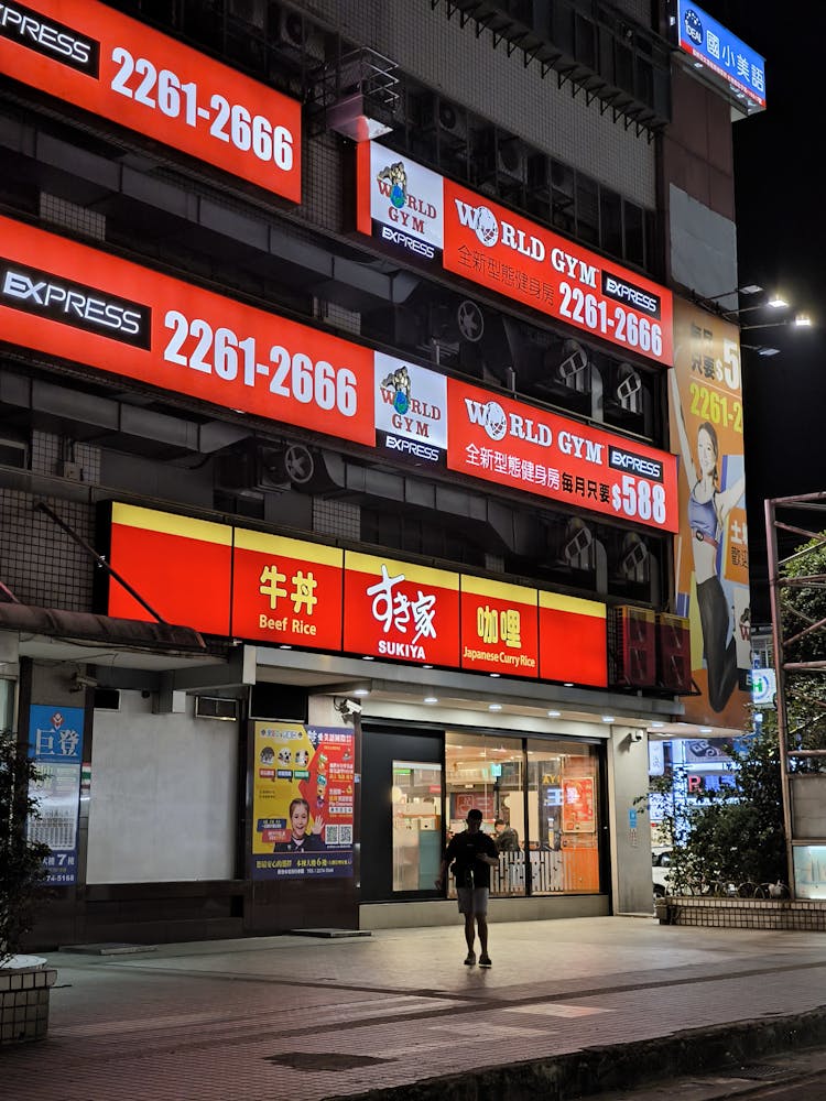 Advertisements On Building Wall At Night