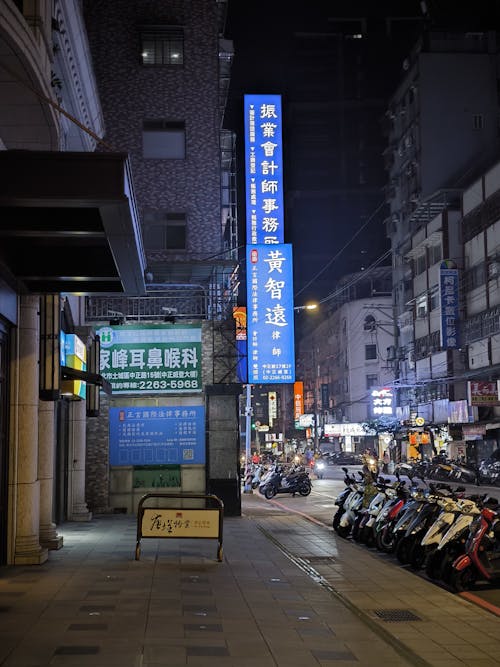 A Street Illuminated with Signs at Night 