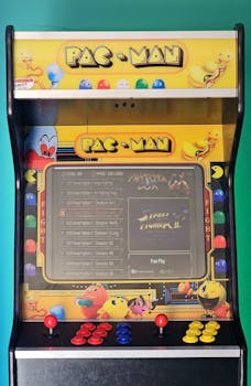 Close-up of a classic Pac-Man arcade machine with vibrant colors and controls.
