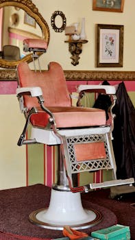 A vintage barber chair in an empty classic salon with ornate decor and mirrors.