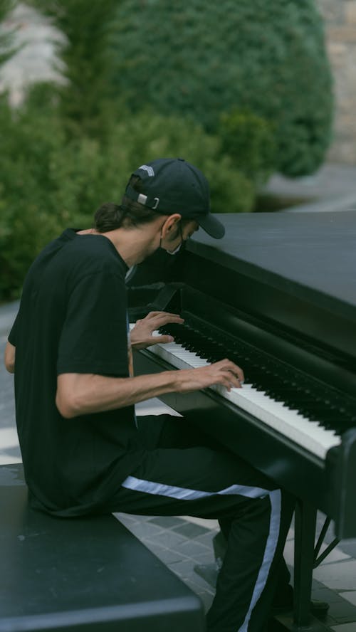 Man Playing on Piano on a Street