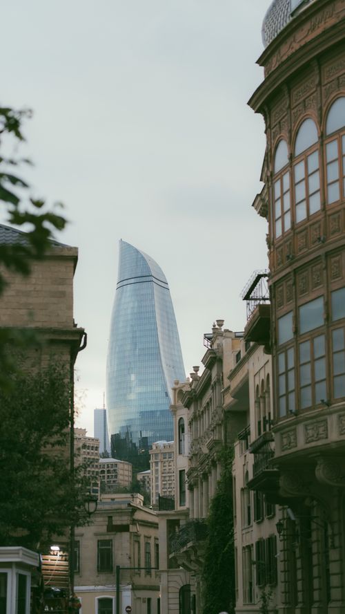 Free Baku's urban landscape showcasing the iconic Flame Towers and historic architecture. Stock Photo