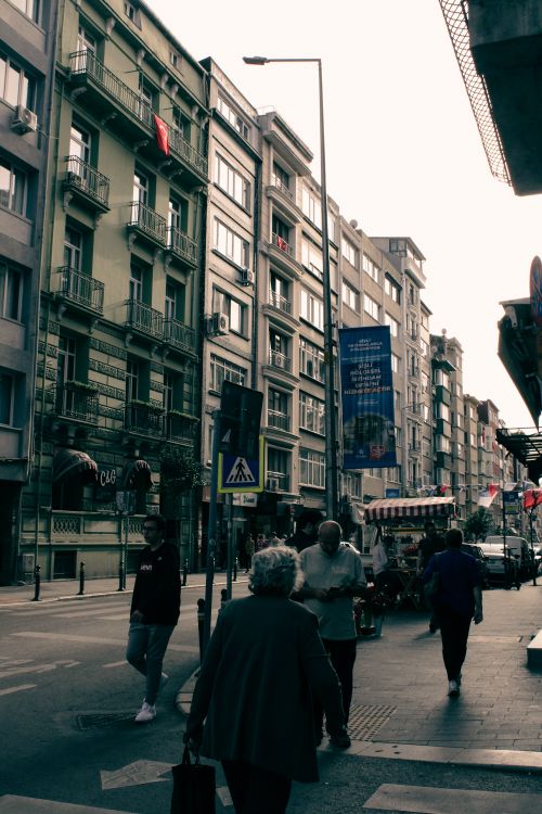 Free Bustling city street with pedestrians and residential buildings in an urban setting. Stock Photo