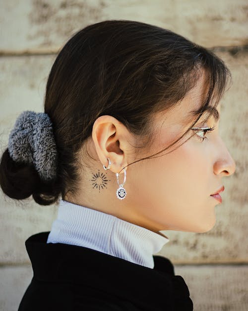 Side Portrait of a Young Woman with Hair in a Bun 