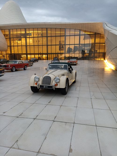 Free Classic Morgan roadster parked at Heydar Aliyev Center in Baku, Azerbaijan at twilight. Stock Photo