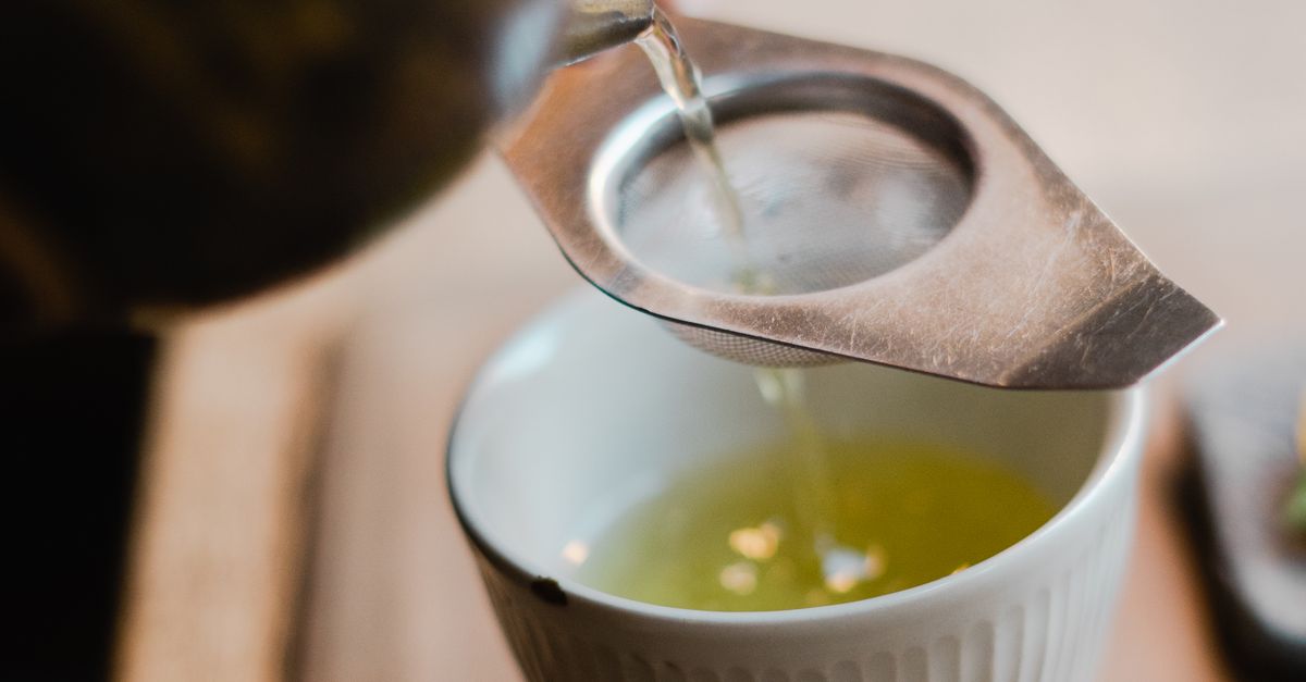 Close-up of Tea Being Poured into a Cup through a Strainer · Free Stock ...