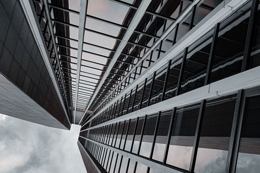 Dramatic perspective of a modern skyscraper in Frankfurt, Germany showcasing geometric design.