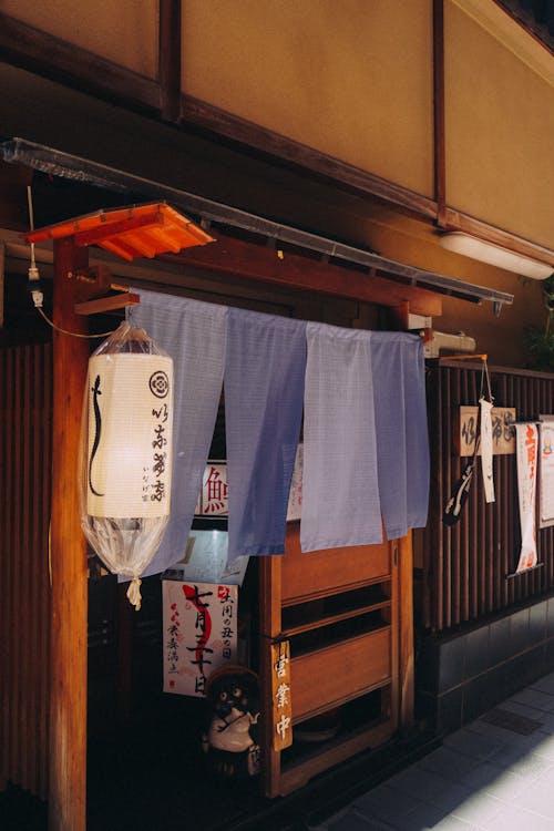 Lantern and Fabrics Hanging by Building Wall