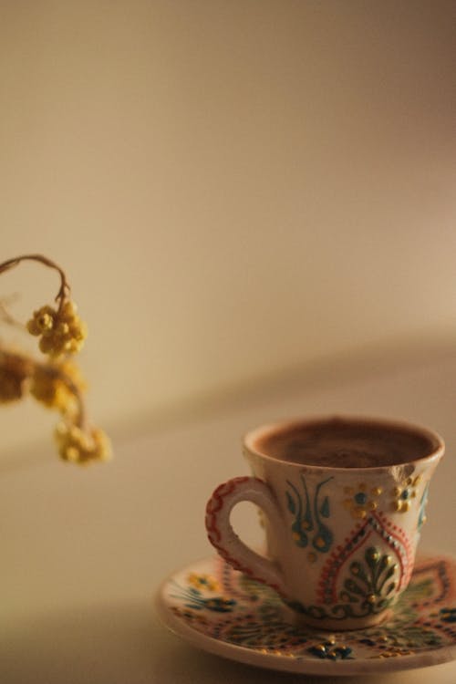 Close-up of a Cup of Coffee with a Floral Pattern 