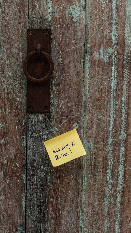 Rusty Handle on Wooden Door with Sticky Note