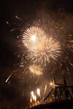 Spectacular fireworks display lighting up the night sky above Liberty Bridge in Budapest.