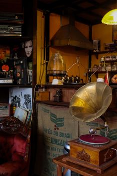 Cozy bar interior featuring a vintage gramophone, eclectic decor, and retro ambiance.