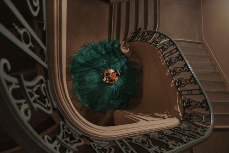 Woman Standing At The Bottom Of The Stairs 