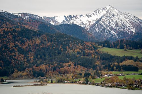 Free Aerial view of a picturesque mountain and forest landscape in autumn with a serene lake. Stock Photo