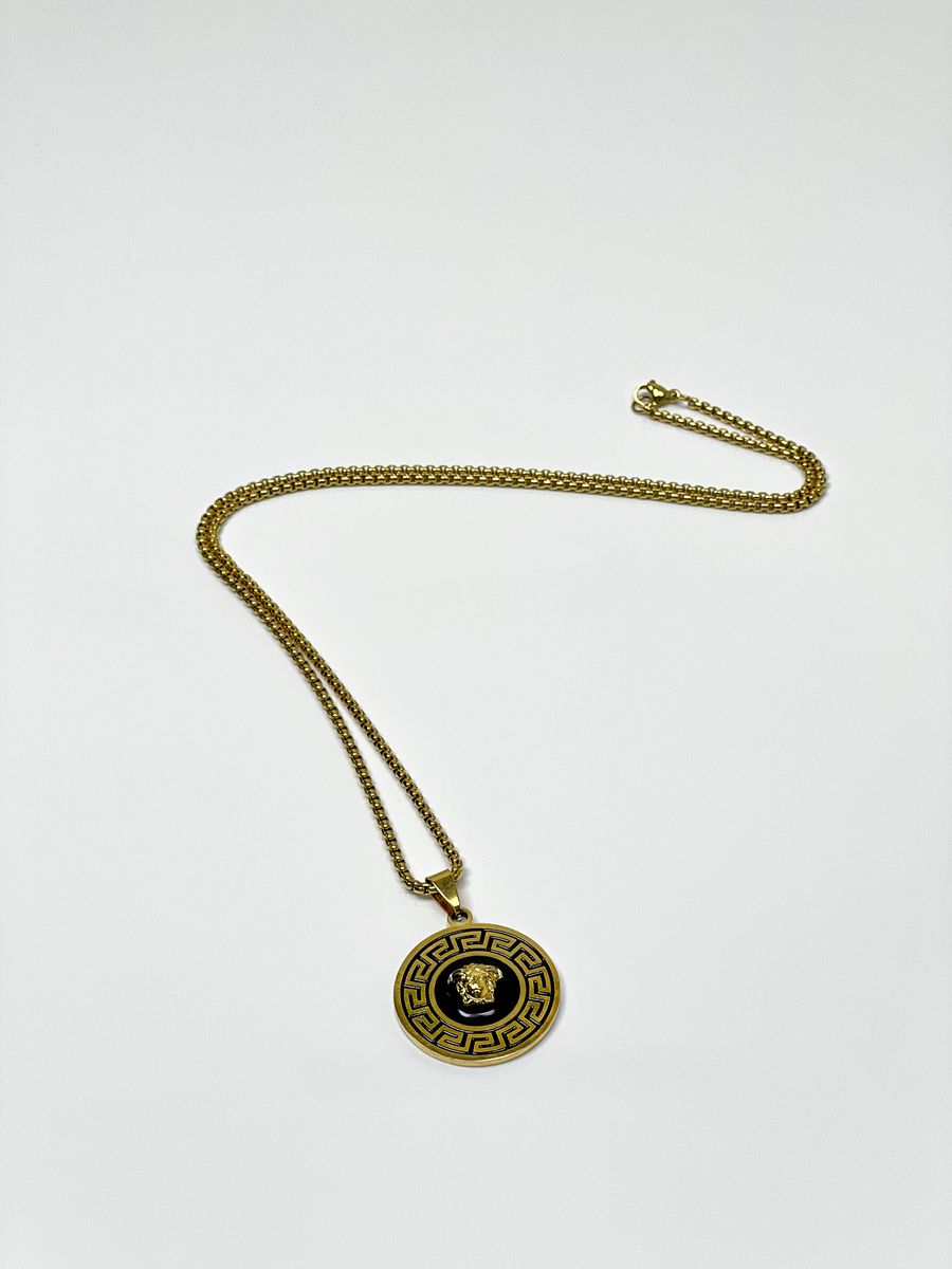 Gold chain necklace with ornate medallion pendant