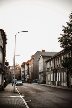A tranquil residential street with historic buildings at sunset.