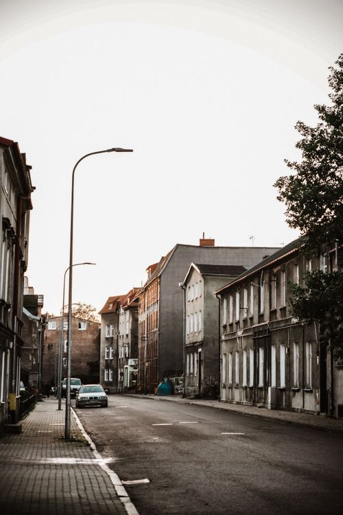 Free A tranquil residential street with historic buildings at sunset. Stock Photo