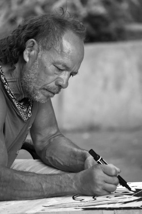 Elderly Artist Drawing on Paper