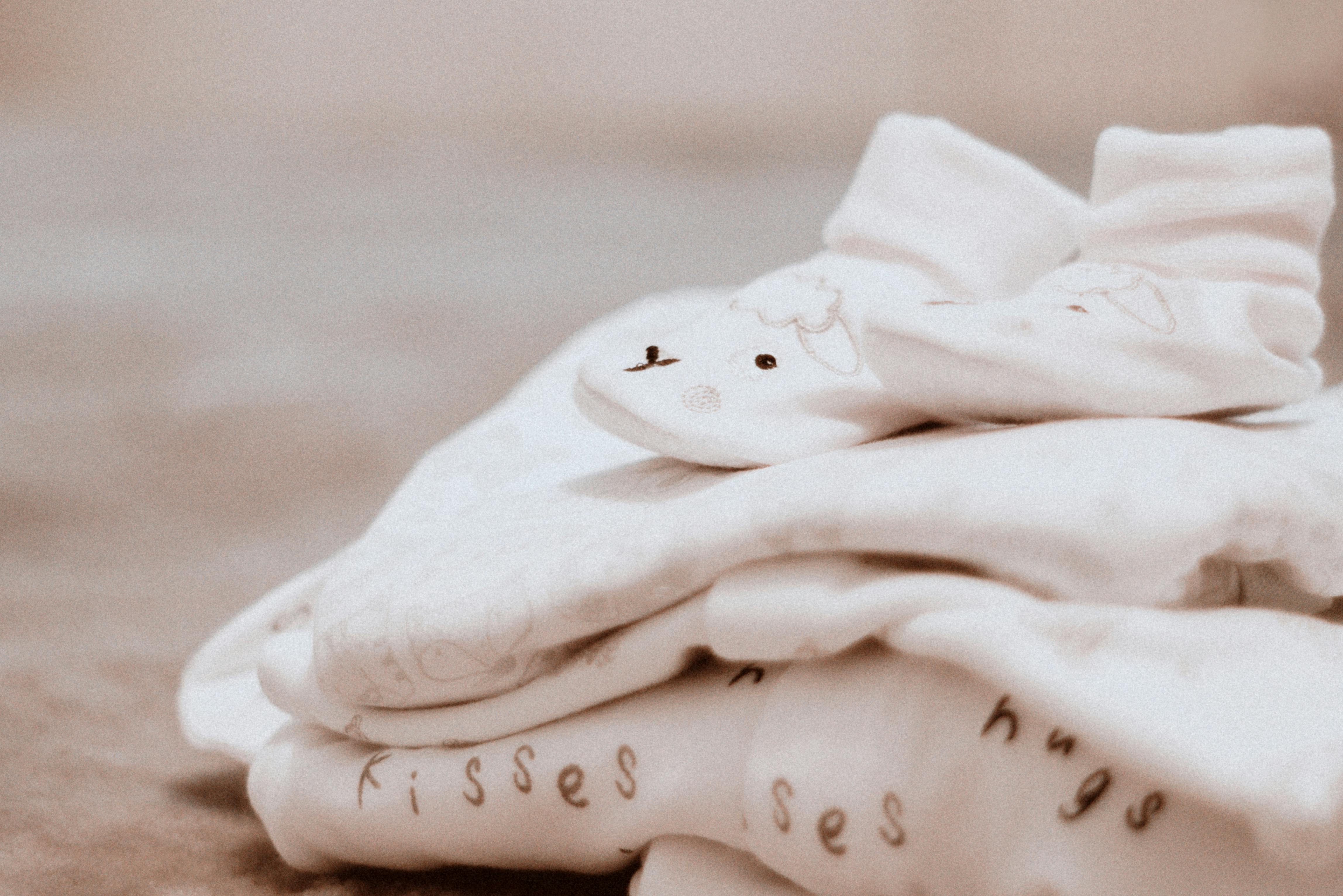 pair of baby s white socks on white textile