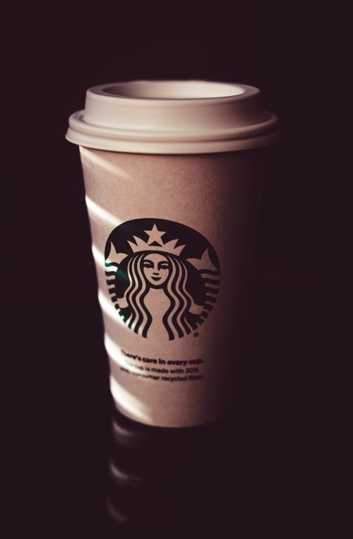 Free A stylish photo of a Starbucks coffee cup with dramatic lighting and shadows. Stock Photo