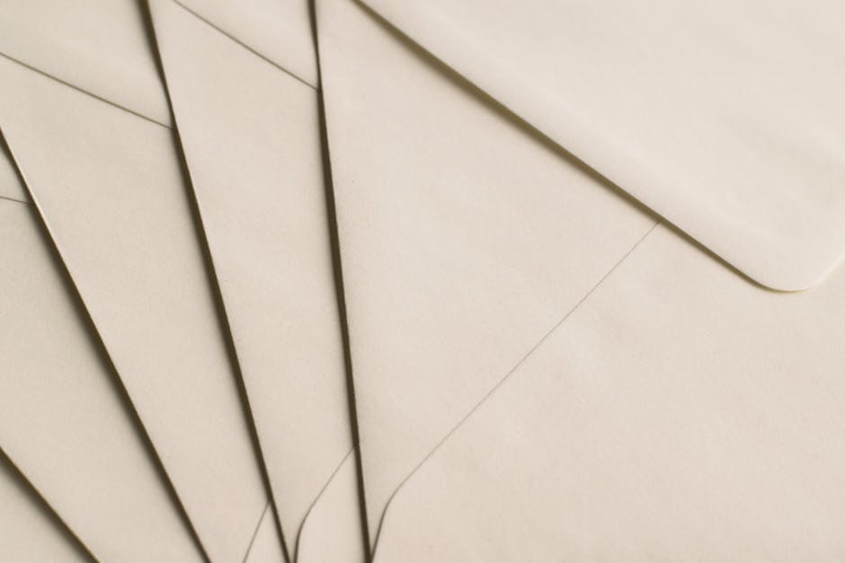 A close-up photo of beige envelopes arranged on a neutral background, ideal for stationery themes.