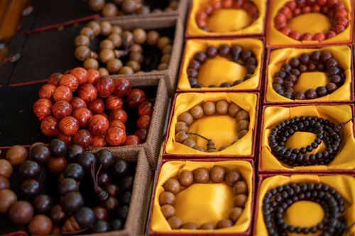 Free Close-up of colorful wooden bead bracelets in decorative boxes. Stock Photo