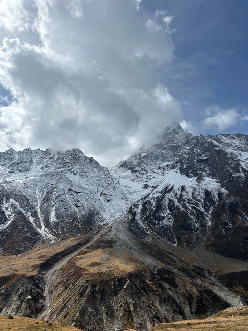 Free A breathtaking view of snowcapped mountain peaks under a dramatic sky. Stock Photo