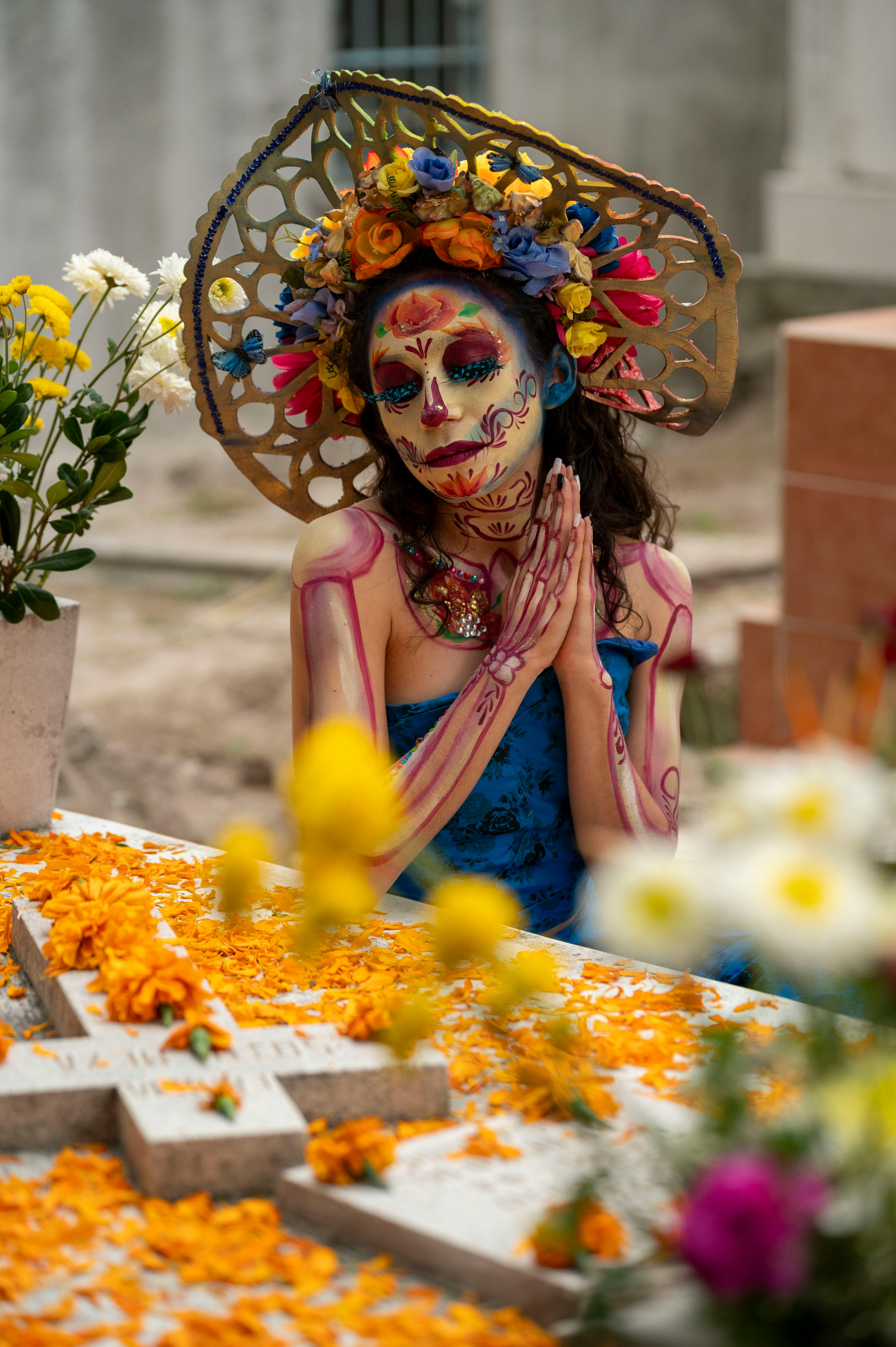 woman in traditional makeup sitting and praying