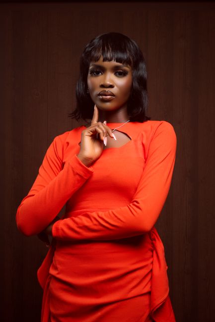 Striking portrait of a black woman in a red dress, exuding elegance and confidence.