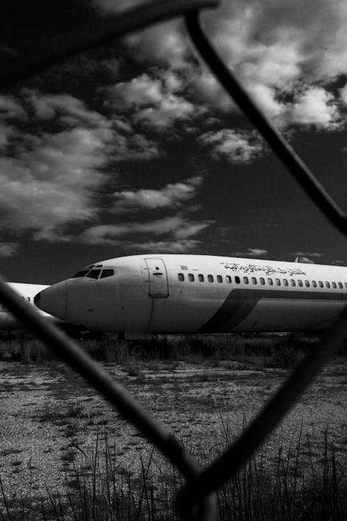 Scrapped Airliner Through the Fence of Aircraft Boneyard 