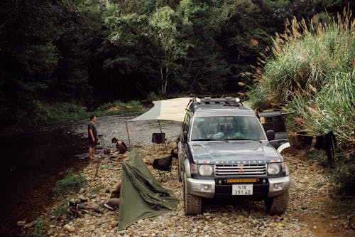 Black Mitsubishi Car by the Stream