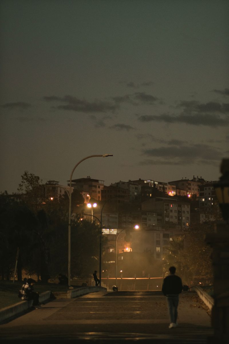 Silhouette of a Man Walking on the Street at Night · Free Stock Photo