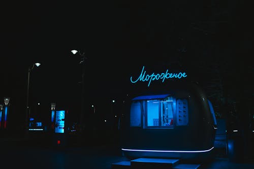 Neon Lit Food Truck Parked at Night