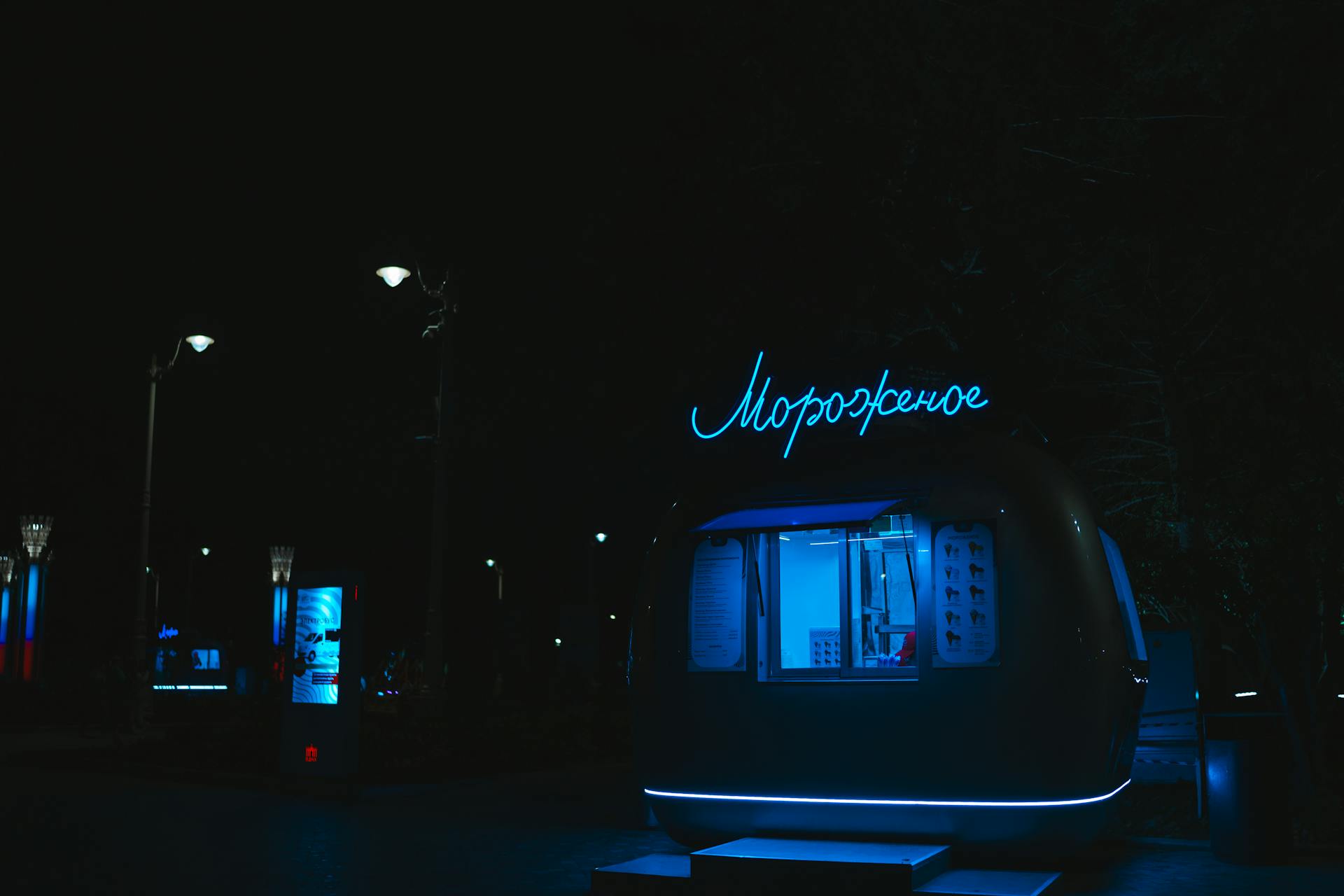 Neon Lit Food Truck Parked at Night