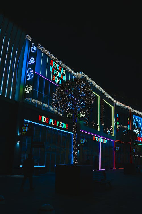 Illuminated Exterior of a Modern Building in City at Night 