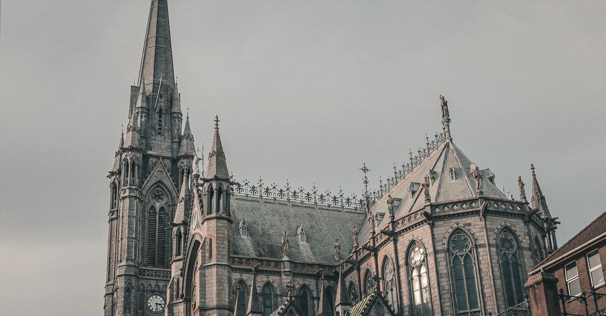 St. Colman's Cathedral with its Gothic architecture in Cobh, Ireland, under a muted sky.