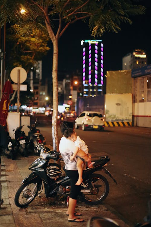 Father with Motorbike Holding Son at Night