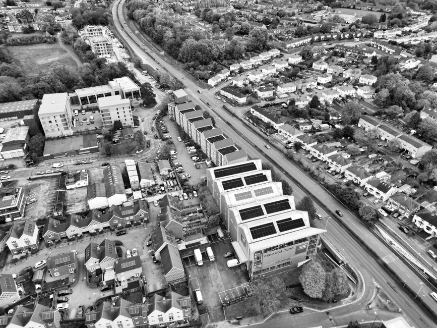 Black and white aerial shot of urban residential area with solar panels in Hertfordshire, UK.