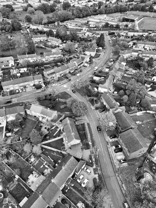 Free Black and white aerial view of a suburban neighborhood in Hertfordshire, England, showcasing houses and streets. Stock Photo