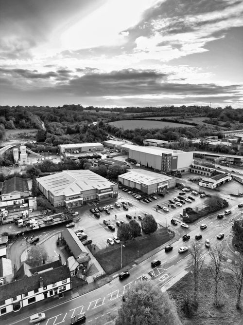 Free Black and white aerial shot of Hertfordshire showcasing industrial buildings and surrounding landscape. Stock Photo