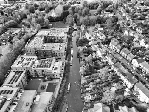 Free Black and white aerial view showcasing Hertfordshire's urban landscape and canal. Stock Photo