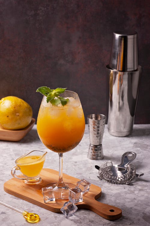 Passion Fruit Cocktail with Ice Cubes Decorated with Mint Leaves