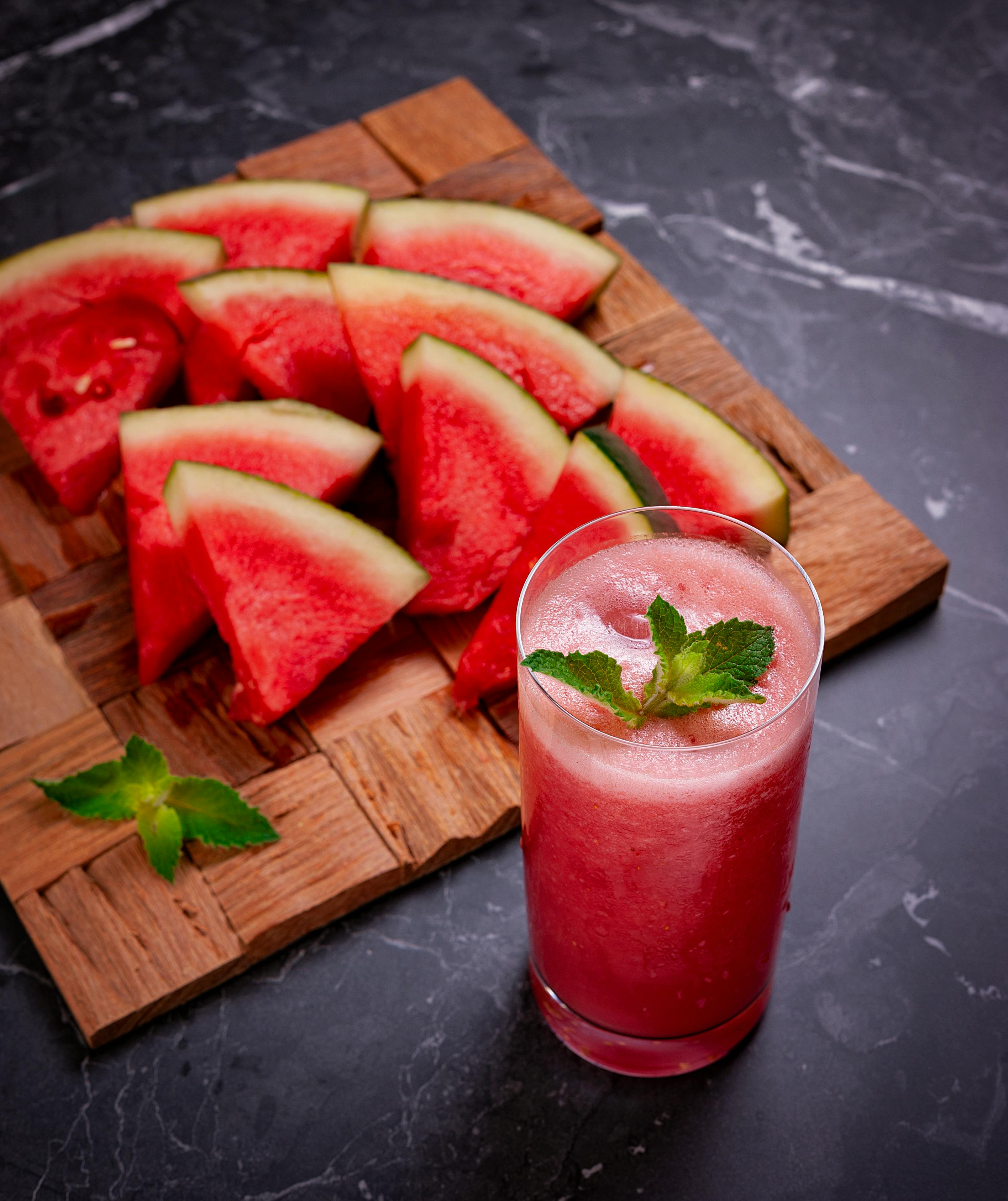 Free Wooden Tray with Watermelon Slices and a Glass of Slushie Stock Photo