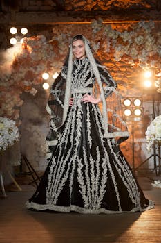 Elegant portrait of a bride in a detailed black and white gown with veil.