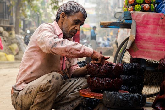 South Asian potter in a bustling street market carefully crafting traditional terracotta pottery.